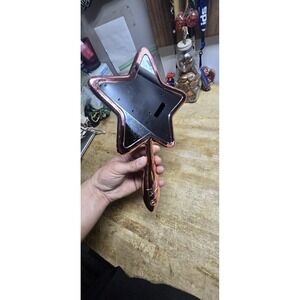 Jeffree Star Cosmetics Rose Gold Chrome Star Hand Mirror.